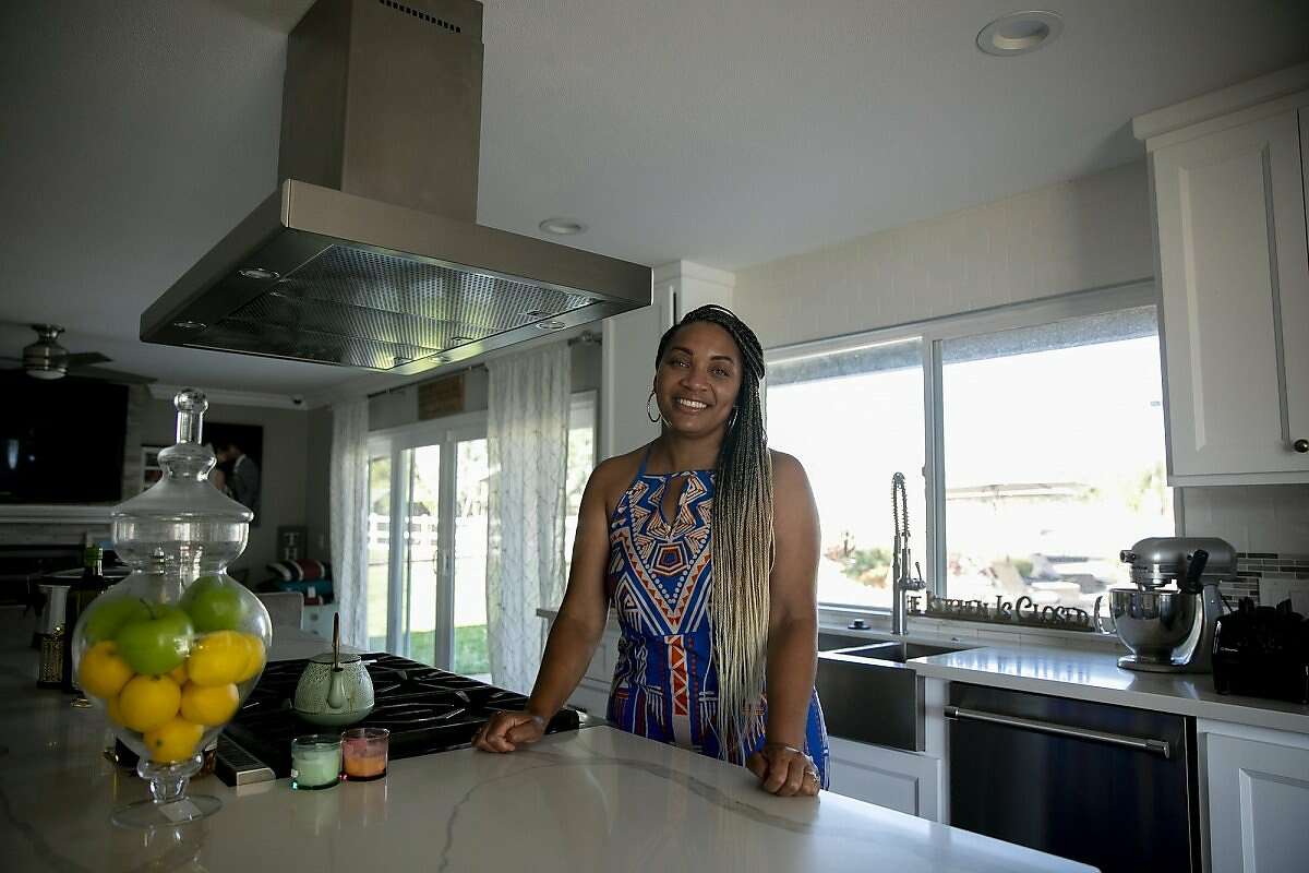 Sharie Wilson in the kitchen of her remodeled Elk Grove home on June 22, 2020. Wilson says that when the bought the home it was the ‘worst on the block’ but was able to turn it into a space that she’s proud of.