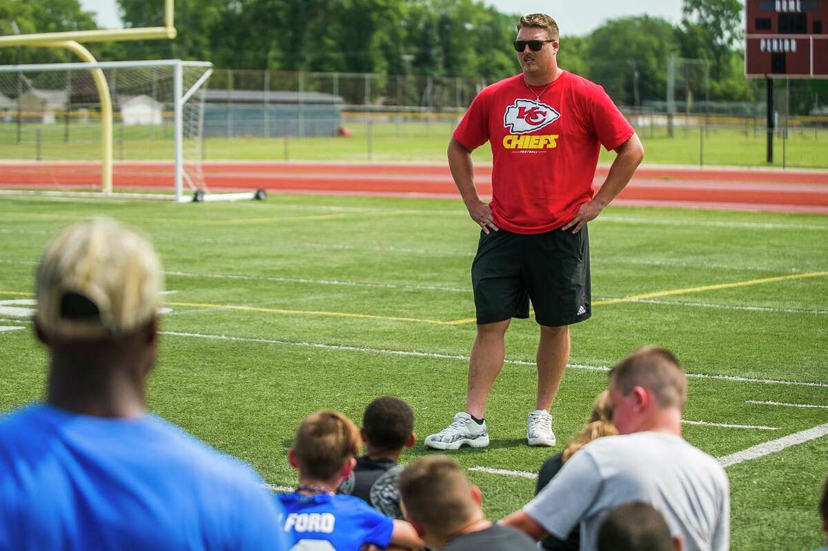 Kansas City Chiefs' Andrew Wylie talks to a group of fifth- and sixth-graders during a July 9, 2019 youth football camp at Midland High.