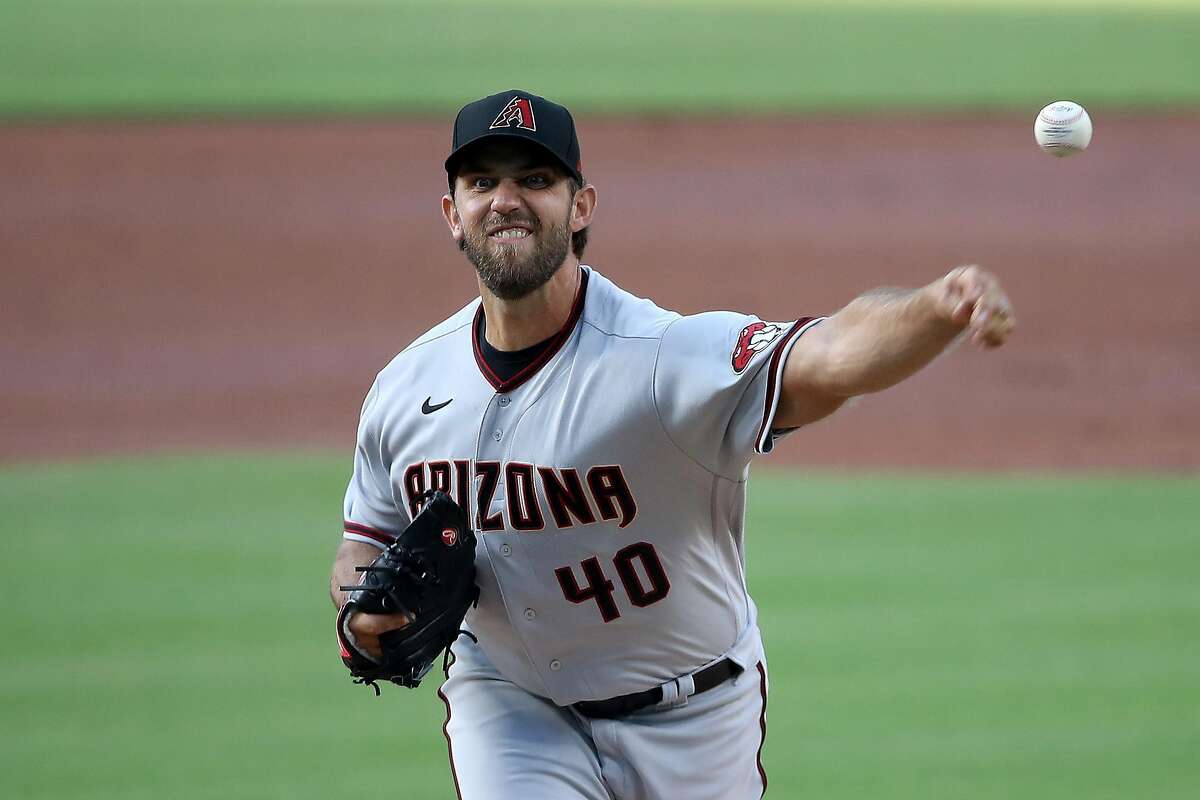 Madison Bumgarner throws in the first inning Friday, his first without a Giants jersey.