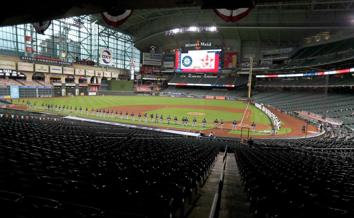 Mariners and Astros line up in an empty Minute Maid Park.