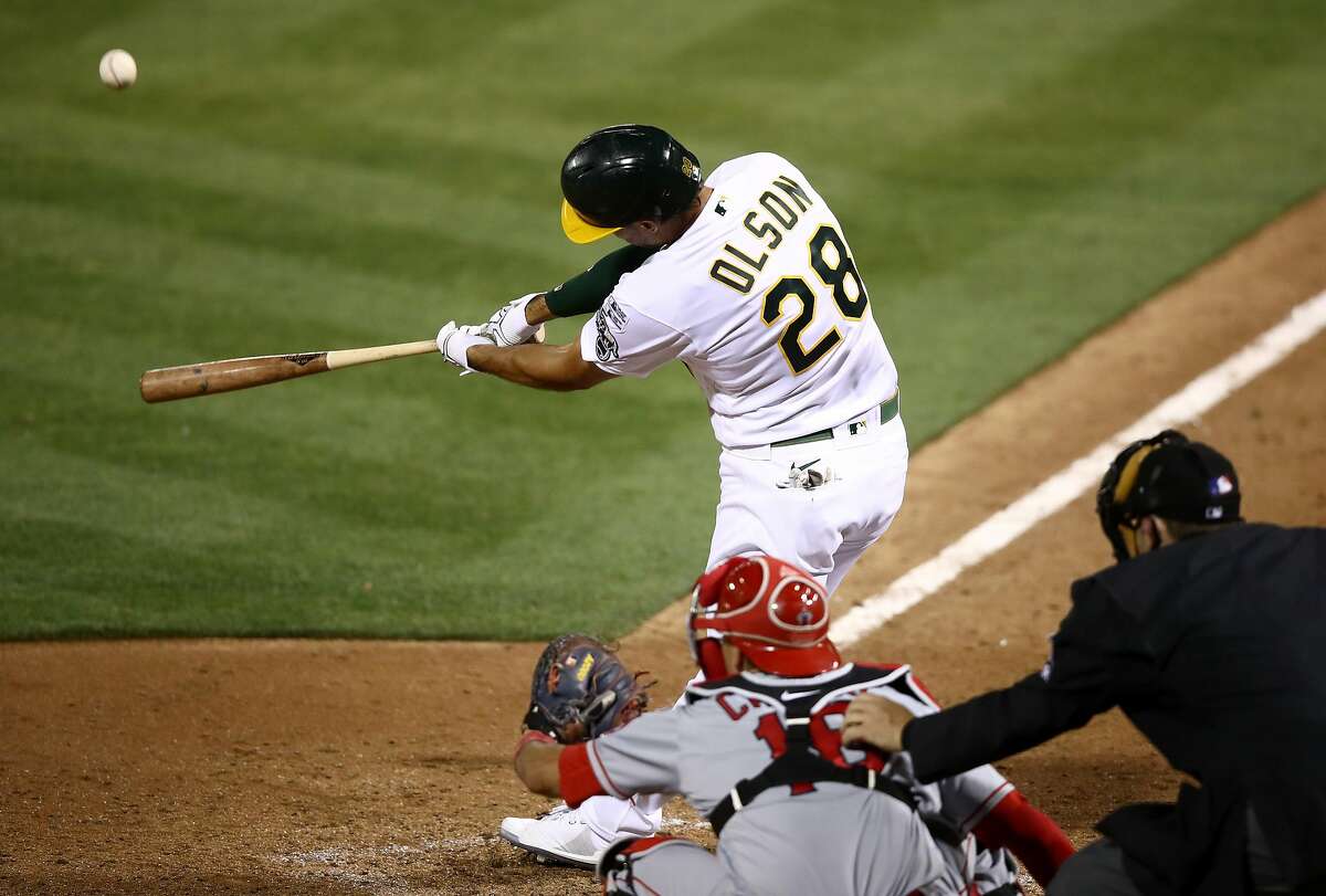 OAKLAND, CALIFORNIA - JULY 24: Matt Olson #28 of the Oakland Athletics hits a grand slam home run in the tenth inning to beat the Los Angeles Angelsduring opening day at Oakland-Alameda County Coliseum on July 24, 2020 in Oakland, California. The 2020 season had been postponed since March due to the COVID-19 pandemic. (Photo by Ezra Shaw/Getty Images)