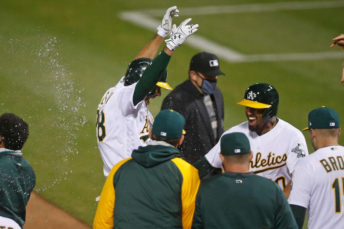 Oakland Athletics' Matt Olson celebrates his walk off grand slam in 10th inning of 7-3 win over Los Angeles Angels during MLB game at Oakland Coliseum in Oakland, Calif., on Friday, July 24, 2020.