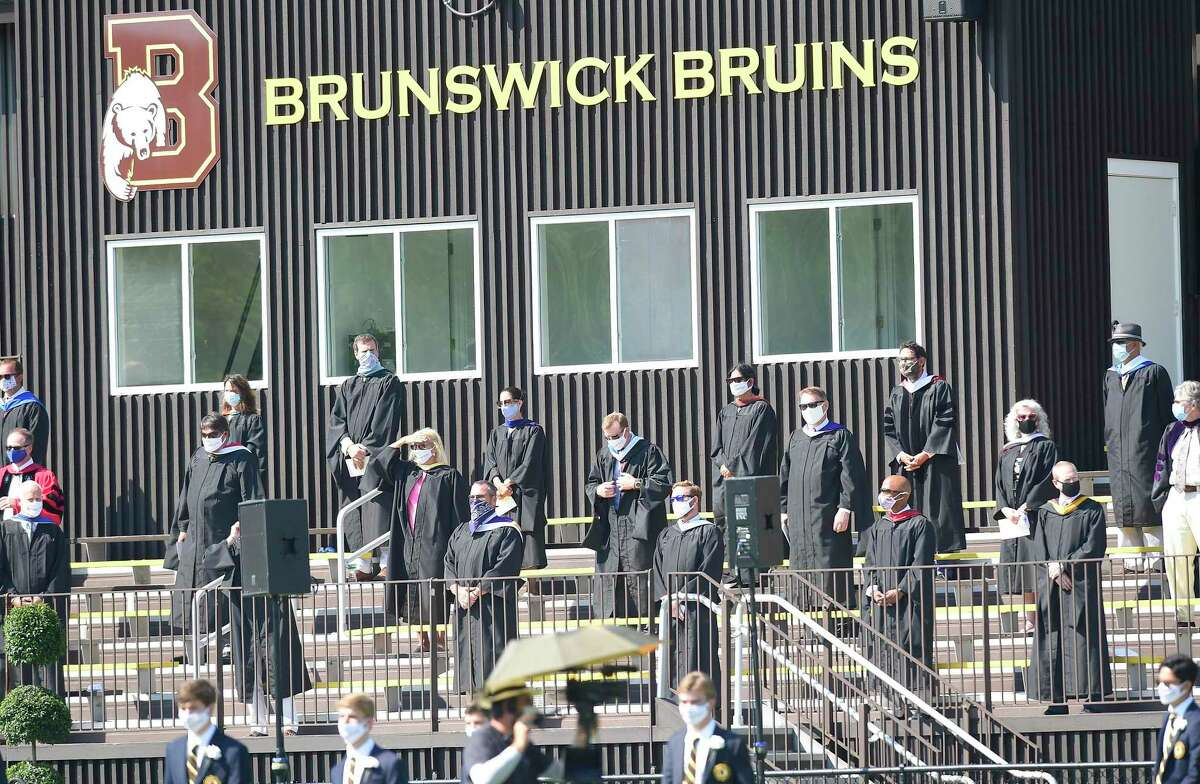 Brunswick School held its One hundred and Eighteenth Commencement ceremony on Cosby Field July 25, 202 in Greenwich, Connecticut. After an invocation by the Rev. Thomas L. Nins, Brunswick Head of School Thomas Philip shared his admiration of the Class of 2020 at the all boys independent school. “Receiving a diploma from Brunswick School marks a significant achievement,” Philip said. “It’s a memorable event in your still young lives. You worked hard to get here and you’ve endured setbacks, disappointments while experiencing successes and triumphs. All of you have represented yourselves and families and our school well throughout.
