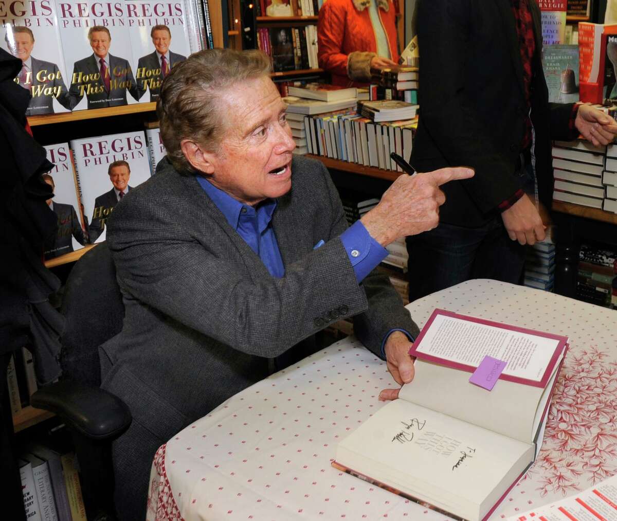 Greenwich resident Regis Philbin signs a copy of his new memoir "How I Got This Way," during an appearance at Diane's Books in Greenwich, Saturday afternoon, Dec. 3, 2011.