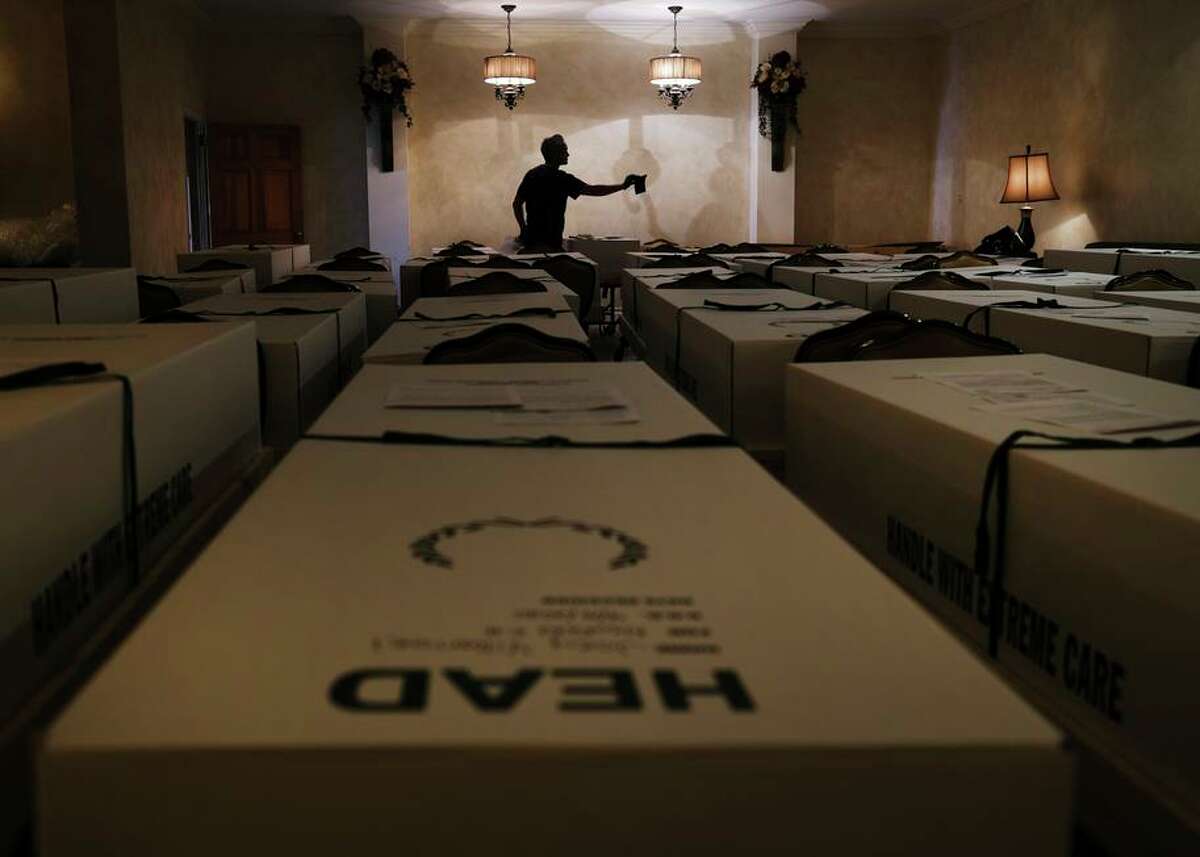 Omar Rodriguez organizes bodies in the Gerard Neufeld funeral home in the Queens borough of New York in April.