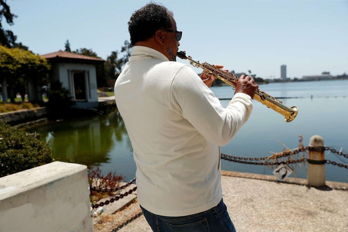 Chaney Timons plays his soprano saxophone at Lake Merritt in Oakland, Calif., on Sunday, July 26, 2020. Timons is recovering from a brain aneurysm and is working on regaining his music chops.