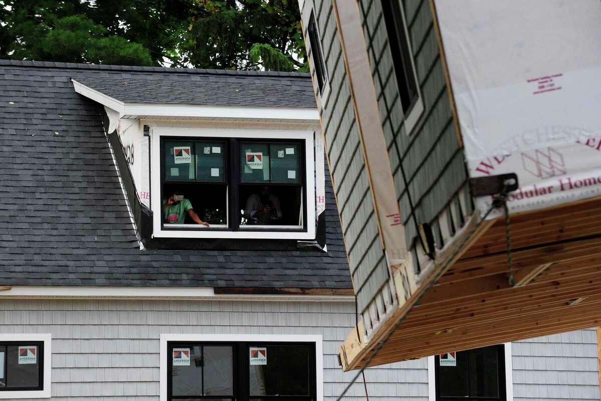 At sunrise, a foundation; by noon, a new home stood in New Canaan