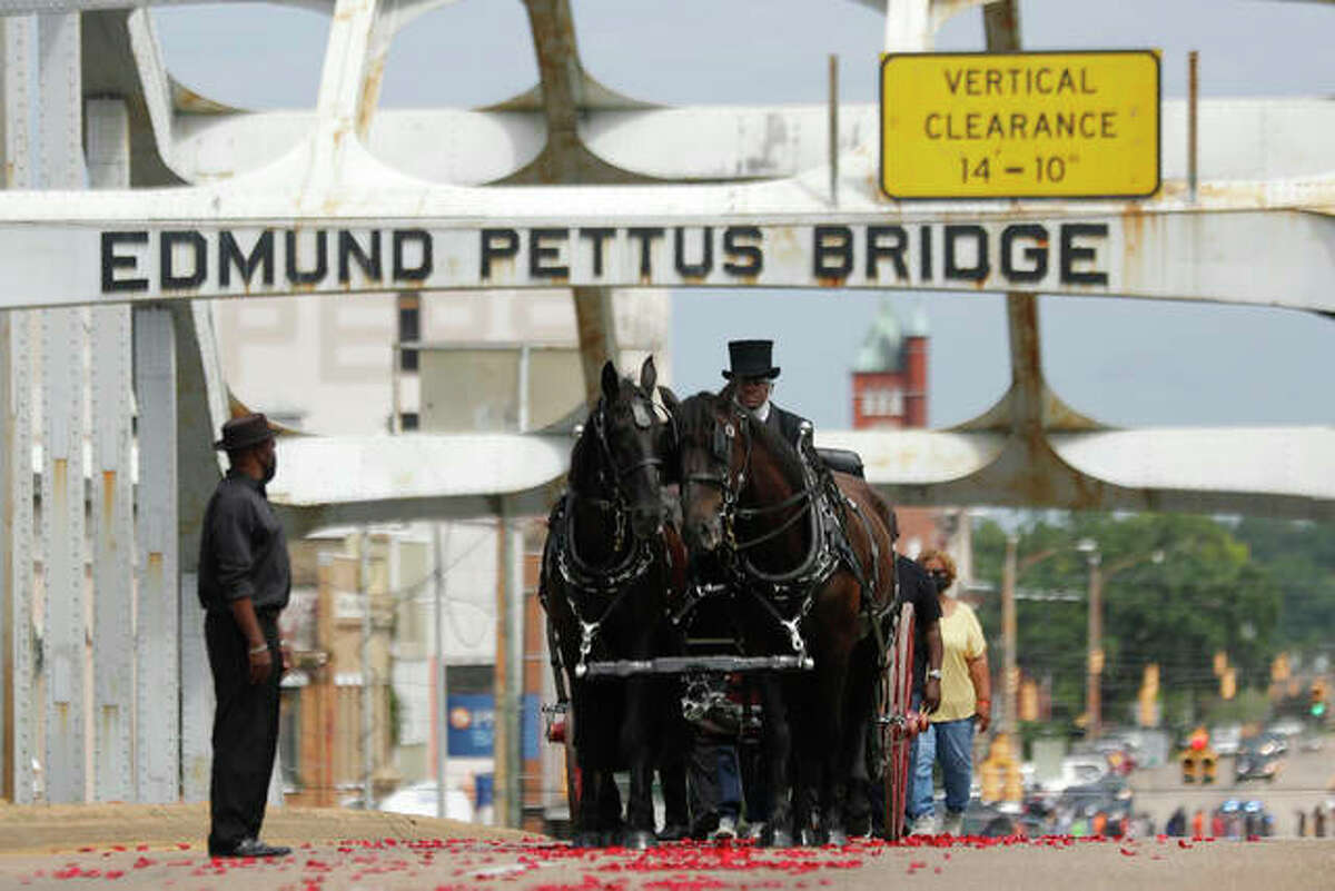 The casket of Rep. John Lewis moves over the Edmund Pettus Bridge by horsedrawn carriage during a memorial service Sunday in Selma, Alabama. Lewis, who carried the struggle against racial discrimination from Southern battlegrounds of the 1960s to the halls of Congress, died July 17.