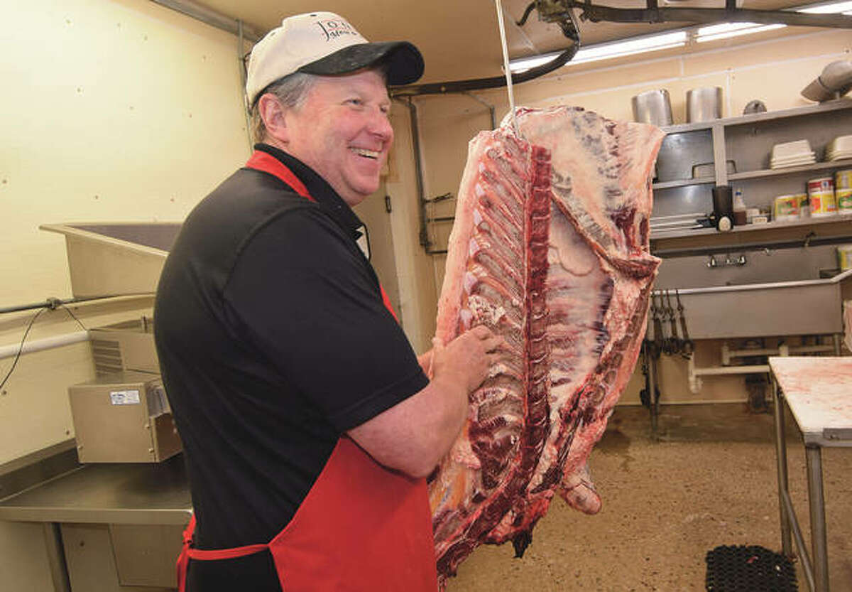 Terry Jones moves a quarter beef to the cutting area at Jones Meat & Locker.