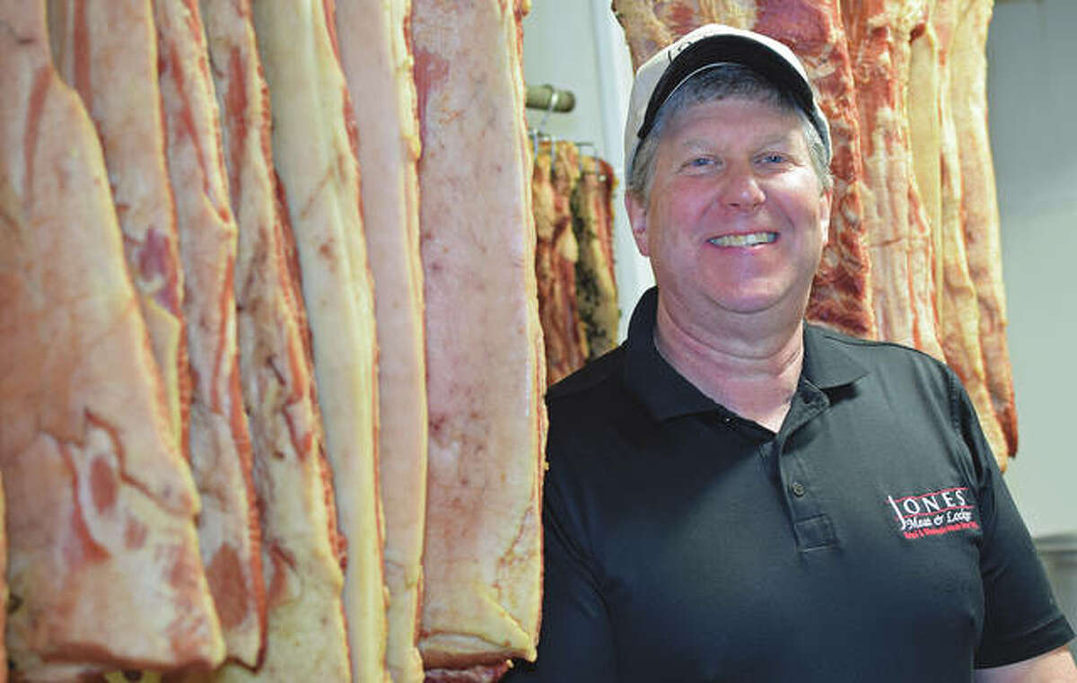 Terry Jones with a Jones Meat & Locker favorite — bacon — being cured.