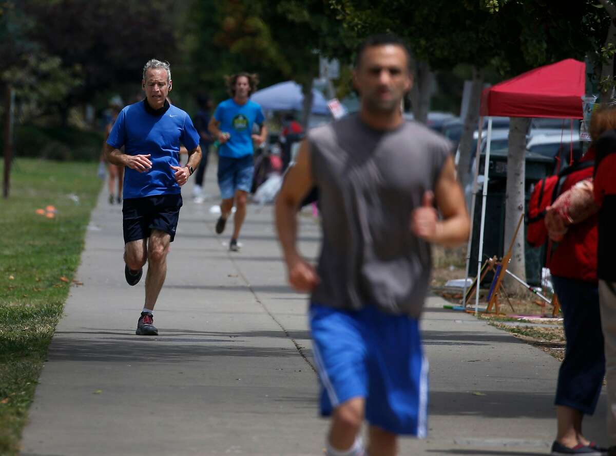Joggers run laps around Lake Merritt in Oakland, Calif. on Thursday, July 16, 2020.