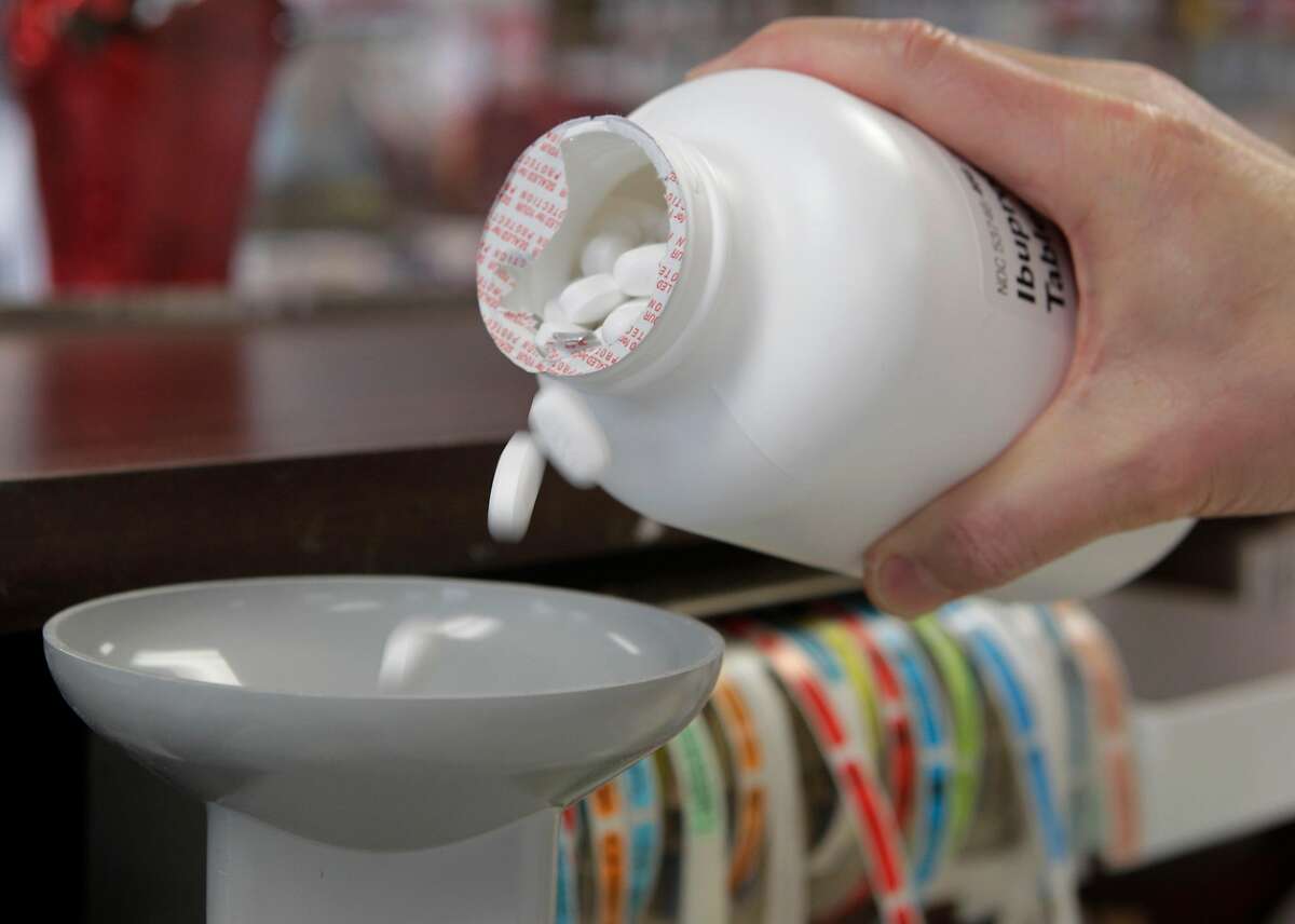 Pharmacist Benson Toy shakes ibuprofen into a pill counter at the Marin Medical Pharmacy in San Rafael, Calif. on Tuesday, Dec. 24, 2013. Toy is alarmed by the skyrocketing costs of generic drugs, with some going up over 300 percent.