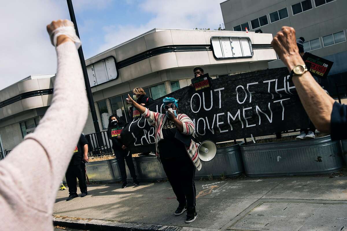 Michelle Cody, A teacher at Willie L. Brown Jr. Middle School and member of United Educators of San Francisco, speaks during a demonstration outside the San Francisco Police Officers Association against the POA's role in support of systematic racism and calling for the defunding of the police on Monday, July 27, 2020 in San Francisco, California.