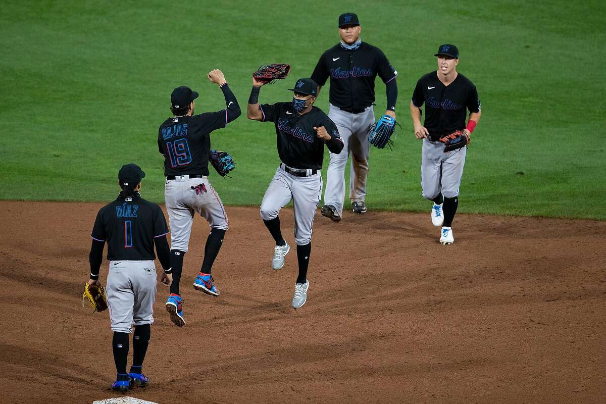 The Miami Marlins celebrate a 5-2 win on Opening Day against the Philadelphia Phillies at Citizens Bank Park on July 24, 2020, in Philadelphia. (Mitchell Leff/Getty Images/TNS)