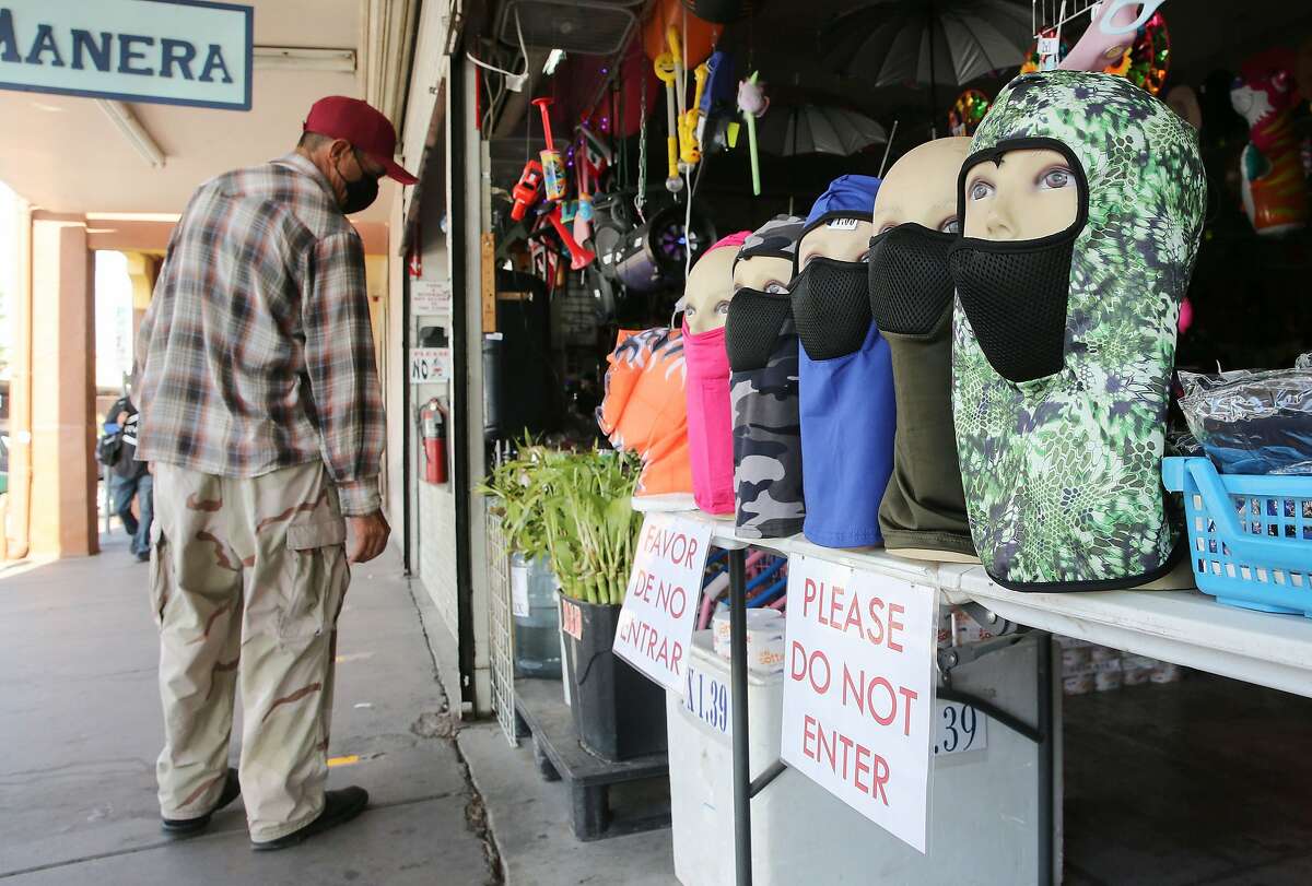 CALEXICO, CALIFORNIA - JULY 24: Face masks are displayed at a shop near the U.S.-Mexico border in Imperial County, which has been hard-hit by the COVID-19 pandemic, on July 24, 2020 in Calexico, California. Unemployment claims in California have reached their highest levels in almost three months with surging coronavirus cases upending plans to reopen the economy. Imperial County currently suffers from the highest death rate and near-highest infection rate from COVID-19 in California. The rural county, which is 85 percent Latino, borders Mexico and Arizona and endures high poverty rates and air pollution while also being medically underserved. In California, Latinos make up about 39 percent of the population but account for 55 percent of confirmed coronavirus cases. (Photo by Mario Tama/Getty Images)
