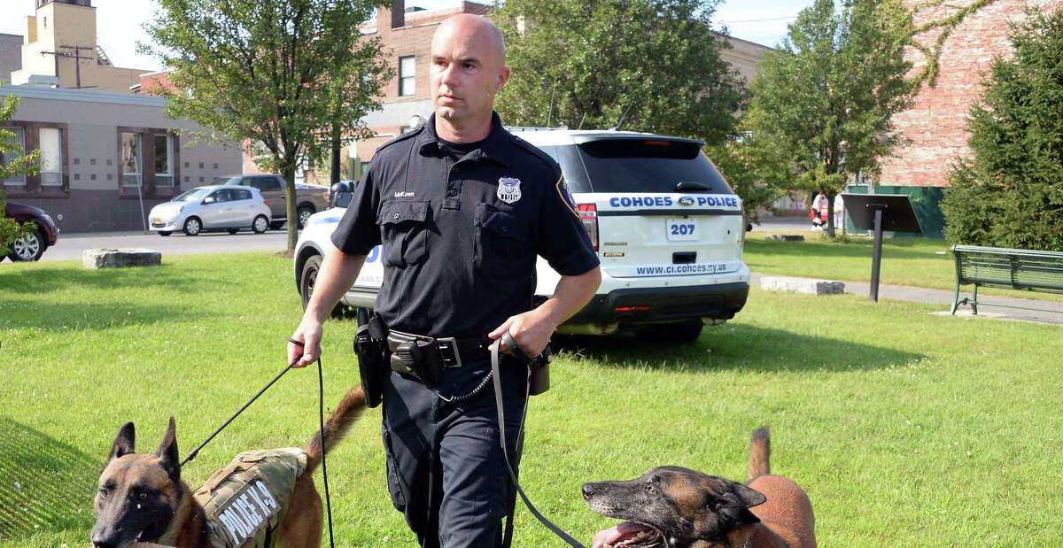 Officer and K-9 handler Sean McKown, with retiring K-9 Jeter, right, and Jeter's son and replacement Loky outside the Cohoes Police Station Wednesday Sept. 9, 2015, in Cohoes, NY.