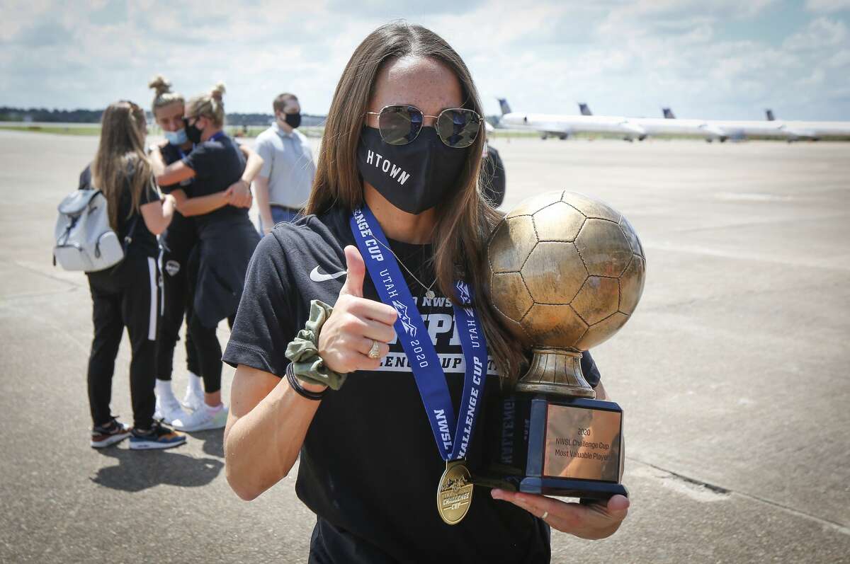 Houston Dash Shea Groom holds her MVP championship trophy after returning home at Atlantic Aviation IAH Monday, July 27, 2020, in Houston.