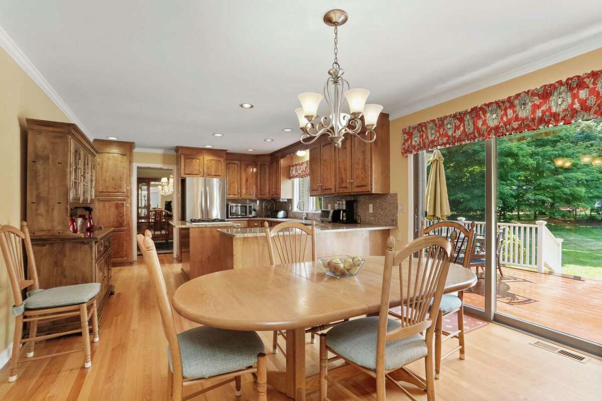 The casual breakfast area has sliding doors to the large raised deck and backyard. This well-maintained home features 3,697 square feet of living space, an attractive and practical blend of formal and informal spaces, hardwood floors throughout, and a classic floor plan which provides plenty of room for entertaining and for everyday living. The front door opens into the center hall foyer, which features two closets and a powder room. From the foyer, French doors open into the good-sized formal living room. The spacious family room features a floor-to-ceiling stone fireplace.