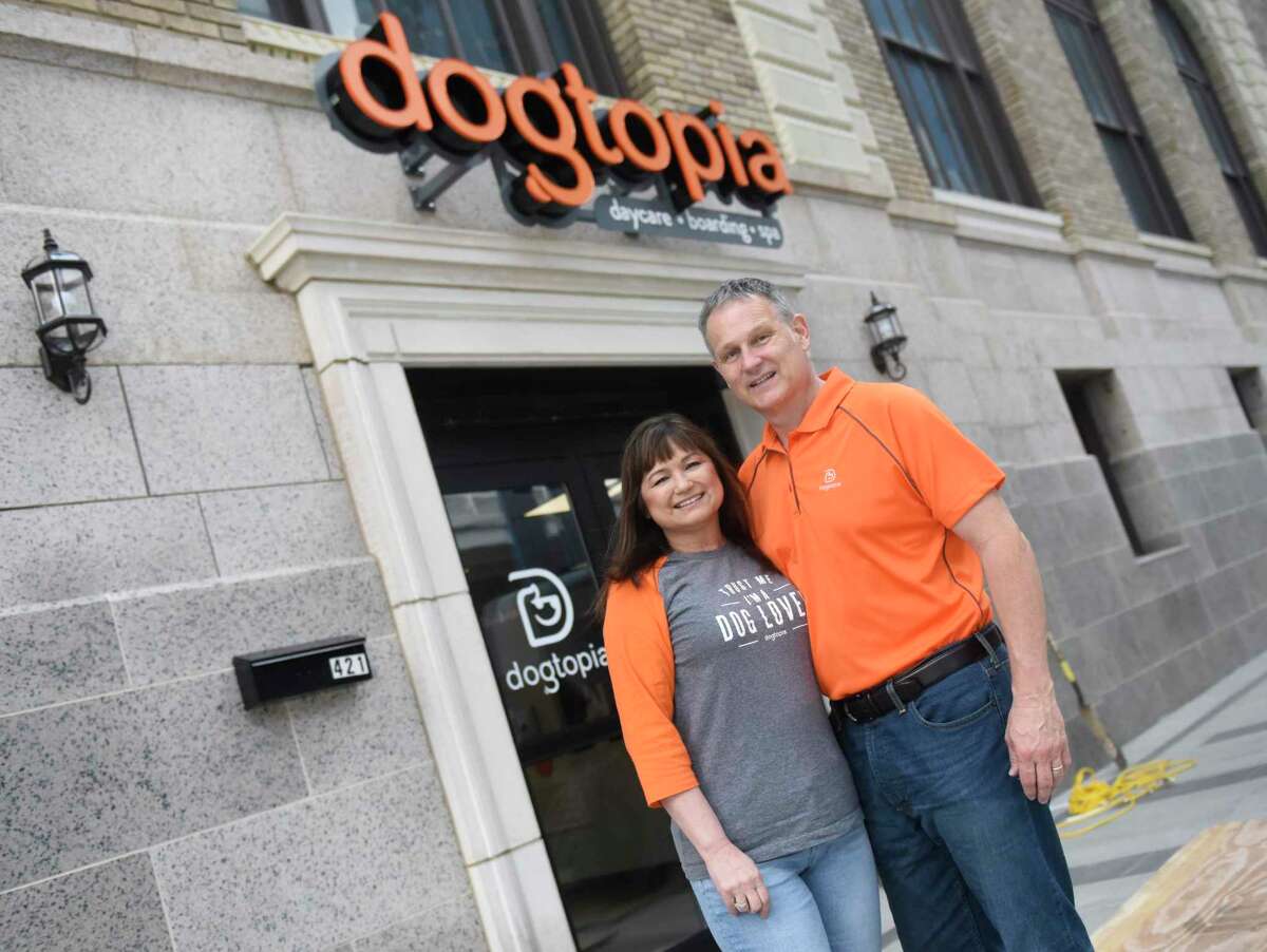 Owners Scott and Elisa Jones pose outside the new Dogtopia dog daycare in Stamford, Conn. Monday, July 13, 2020. The new facility is located in the former post office on Atlantic Street and features daycare, boarding and spa services for dogs.