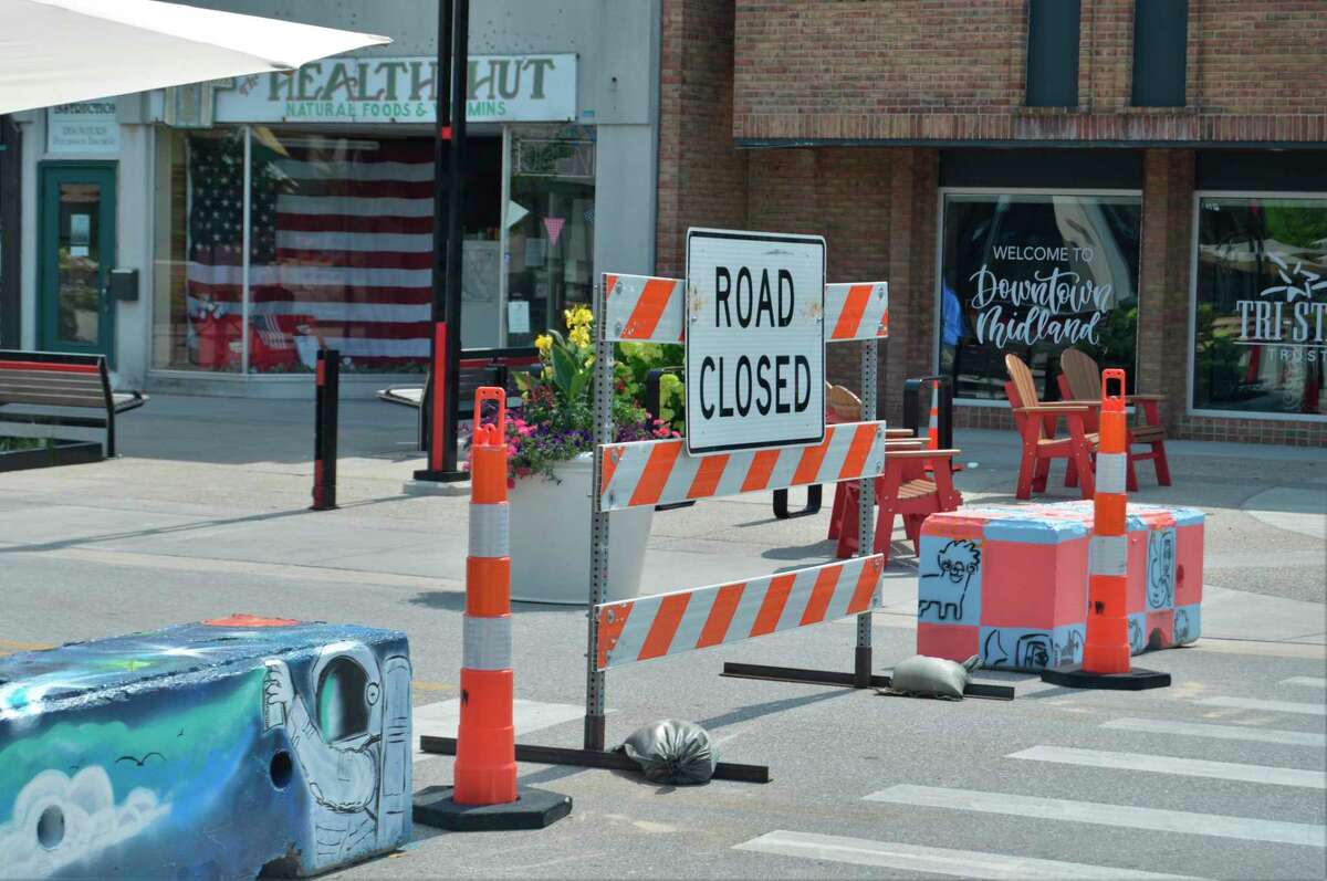 Painted barricades and road signs physically close off two blocks of Main Street in downtown Midland -- between Ashman and Rodd streets -- as a way to allow businesses to expand and allow for room to social distance on July 26, 2020. (Ashley Schafer/ashley.schafer@hearstnp.com)