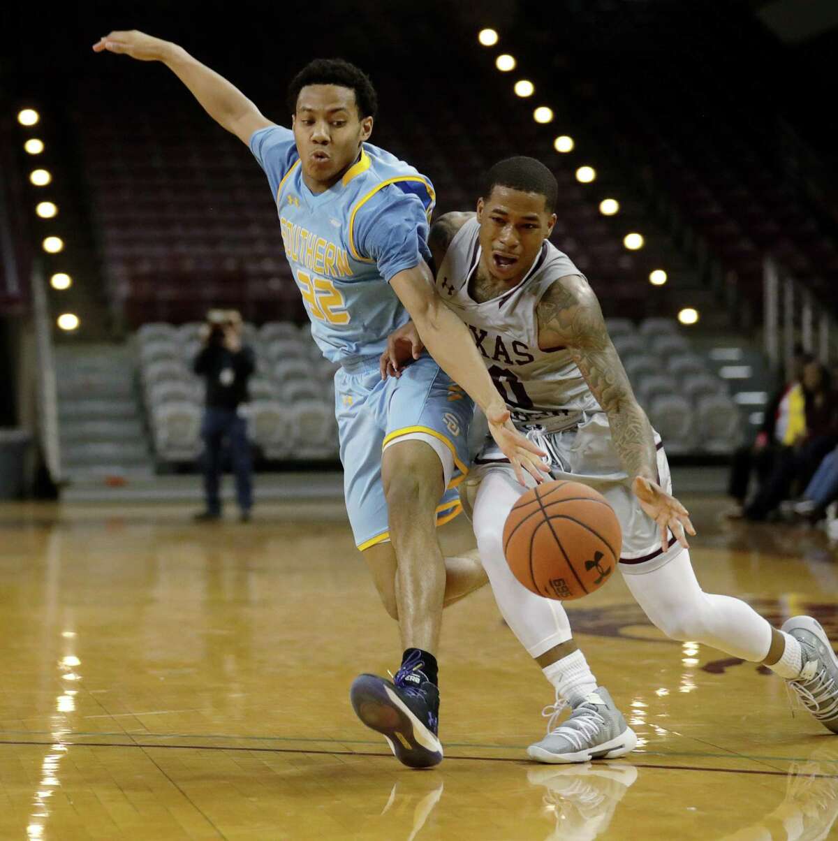 Southern University Jaguars guard Jayden Saddler (32) guards Texas Southern Tigers guard Tyrik Armstrong (20) while he drives to the basket during the second half of a SWAC tournament quarterfinal game at TSU's HPE Arena, Tuesday, March 12, 2019, in Houston.