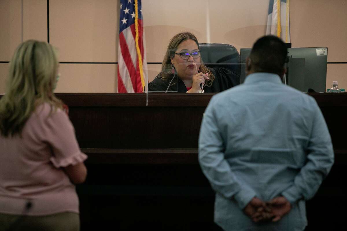 Judge Velia J. Meza talks to defendant Jose Briseño with his attorney, Jennifer Zarka, left, standing by in the 226th District Court at the Cadena-Reeves Justice Center in San Antonio on Tuesday, July 28, 2020.
