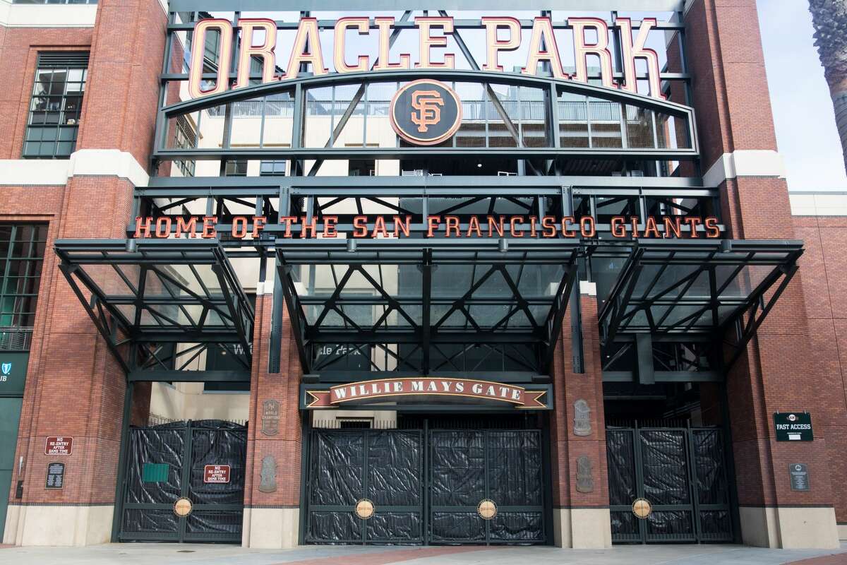 The Willie Mays statue in front of a boarded up Oracle Park during