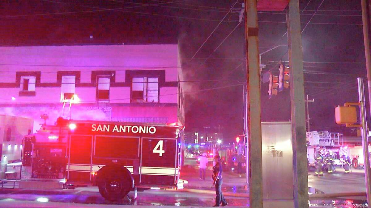 Firefighters pull two from burning building after fire started at