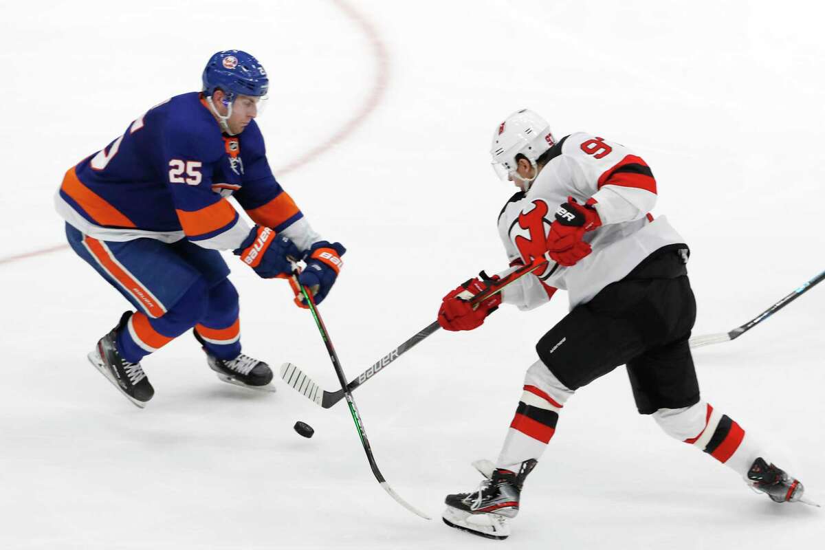 Former Quinnipiac defenseman Devon Toews (25), seen blocking a shot by New Jersey Devils left wing Nikita Gusev (97) during the third period of an NHL hockey game on Jan. 2 has played in 68 games for the New York Islanders during the 2019-20 season. Devon Toews - Quinnipiac University New York Islanders (D)