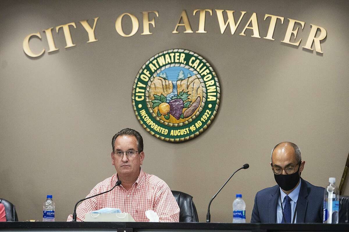 Atwater Mayor Paul Creighton, left, and City Attorney Fran Splendorio, right, attend an Atwater City Council meeting in Atwater, Calif., Monday, July 27, 2020. Gov. Gavin Newsom for the first time is using his newly won financial power to withhold tens of thousands of dollars from Atwater and Coalinga in California’s Central Valley because they are defying state health orders by allowing all businesses to remain open during the pandemic. Officials in the two cities say they won’t give in. (Andrew Kuhn/The Merced Sun-Star via AP)