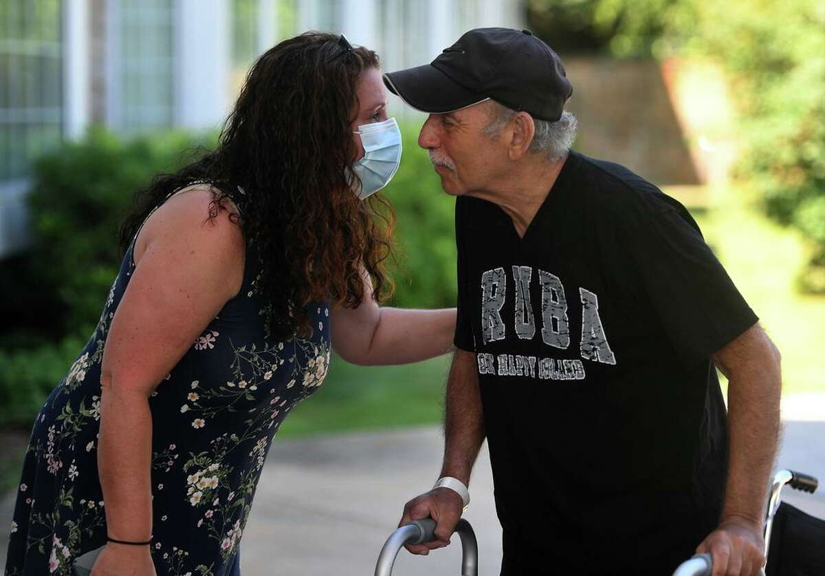 Sheri Ganter, left, of Milford, greets her father, Marty Ganter, 81, of West Haven, as he is released from Gaylord Specialty Care in Wallingford, Conn. on Wednesday, July 29, 2020. Ganter fought a four month battle against COVID-19.