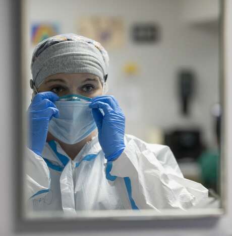Nurse Christina Mathers adjusts her surgical mask, which sits on top of an N95, before checking on her patients at United Memorial Medical Center on July 22, 2020, in Houston. Photo: Godofredo A. Vásquez/Staff Photographer / ? 2020 Houston Chronicle