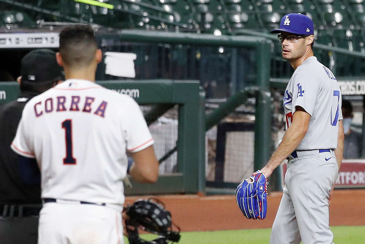 Dodgers reliever Joe Kelly (right) was suspended eight games by MLB on Wednesday after throwing behind Alex Bregman's head and then in on Carlos Correa during Tuesday's game against the Astros.