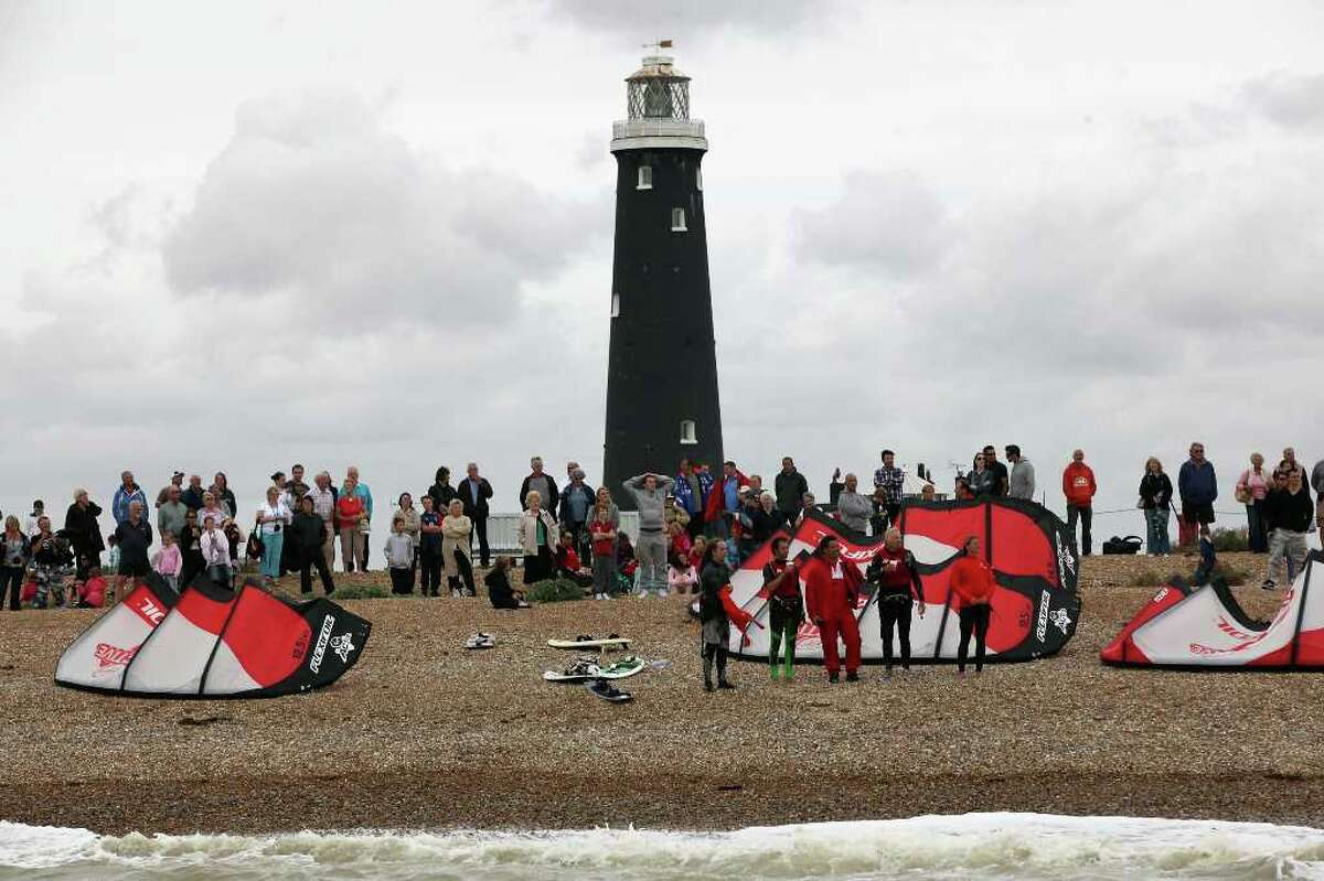 DUNGENESS, UNITED KINGDOM - AUGUST 25: Richard Branson (2nd-R) stands on the beach after failing in his attempt to Kite Surf across the English Channel on August 25, 2010 in Dungeness, England. Due to weather conditions, Mr Branson had to call off the attempt, which was to celebrate his 60th birthday, and have him become the oldest person to Kite-surf across the English Channel. (Photo by Dan Kitwood/Getty Images) *** Local Caption *** Richard Branson