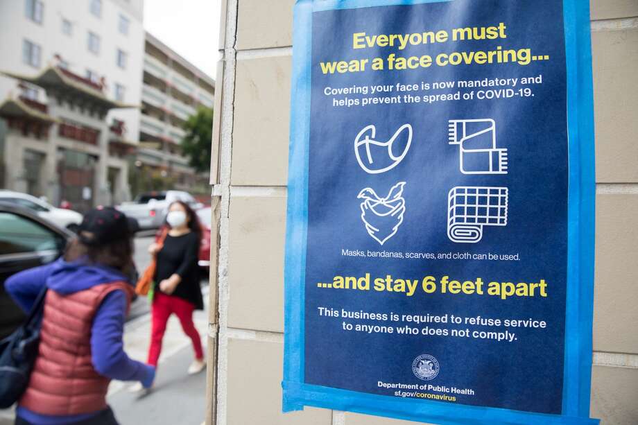 Pedestrians wear masks to protect themselves from the COVID-19 coronavirus in San Francisco's Chinatown neighborhood in San Francisco, Calif. on July 28, 2020. Photo: Douglas Zimmerman/SFGATE / SFGATE