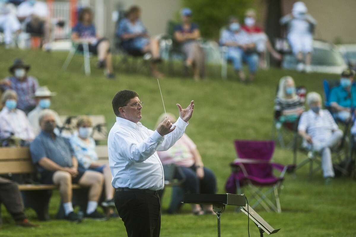 Steve DeRees conducts the Chemical City Band as they perform Wednesday, July 29, 2020 at the Nicholson-Guenther Band Shell in Central Park in Midland. (Katy Kildee/kkildee@mdn.net)