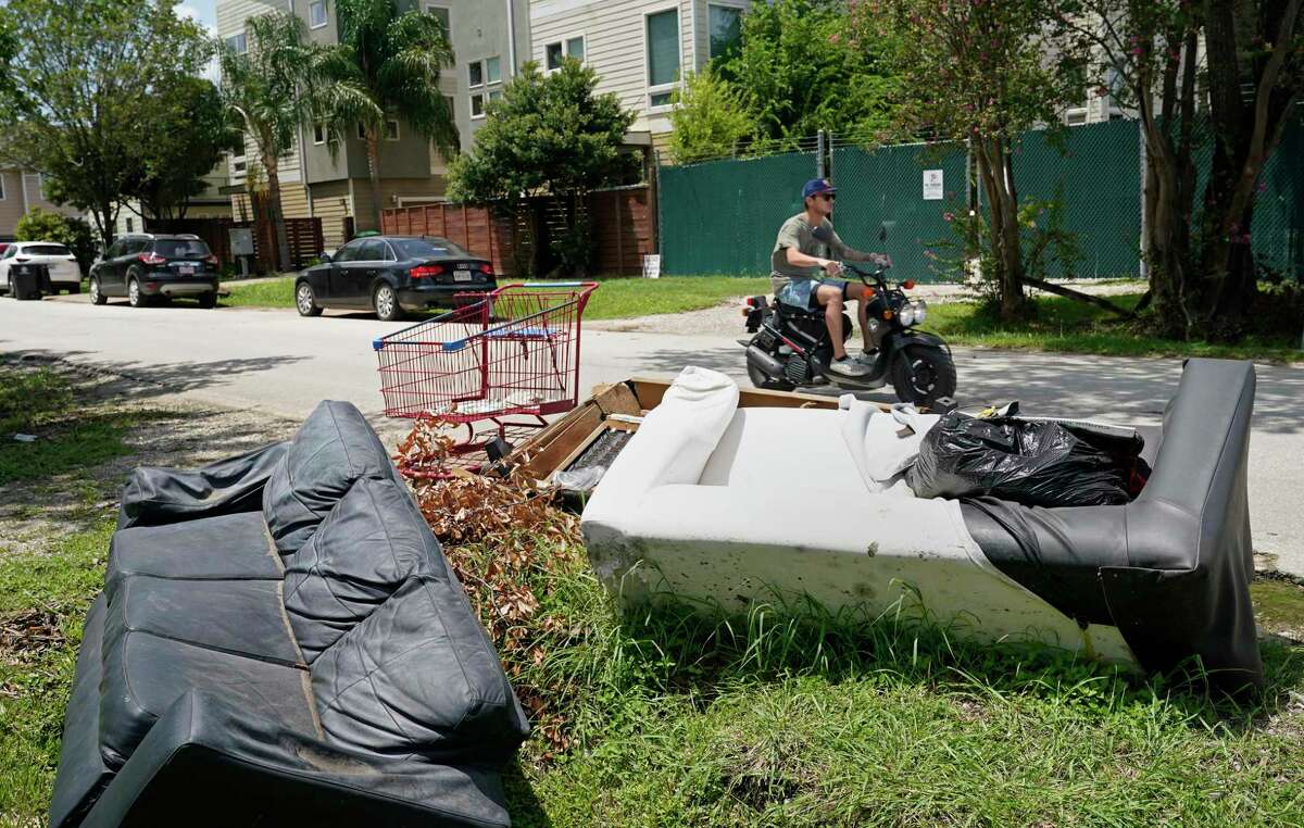 Household and yard debris are shown along West 25th St. near North Durham Dr. Thursday, July 30, 2020, in Houston. Houston’s Solid Waste Managment Department is running behind on junk trash pick-ups because of short staffing due to COVID-19.