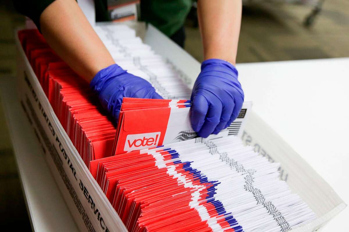 Election workers sort vote-by-mail ballots for the presidential primary at King County Elections in Renton, Washington on March 10, 2020. (Photo by Jason Redmond / AFP) (Photo by JASON REDMOND/AFP via Getty Images)
