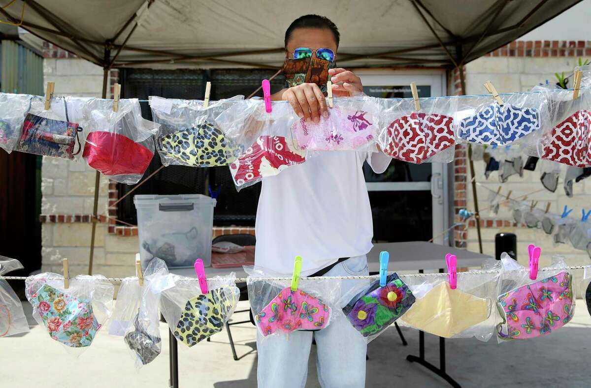 Raul Padron sorts the masks he sells on Commerce Street on the city's Westside on Wednesday, July 8, 2020. Padron's wife makes some of the hundreds of masks he offers for sale. Since the start of the COVID-19 pandemic when supplies of masks were scarce, entrepreneurs like Padron had to fill that demand. And with the latest city and county orders for people to wear masks, Padron and other vendors have a good supply of cloth coverings for the public to help lower the chances of infection.