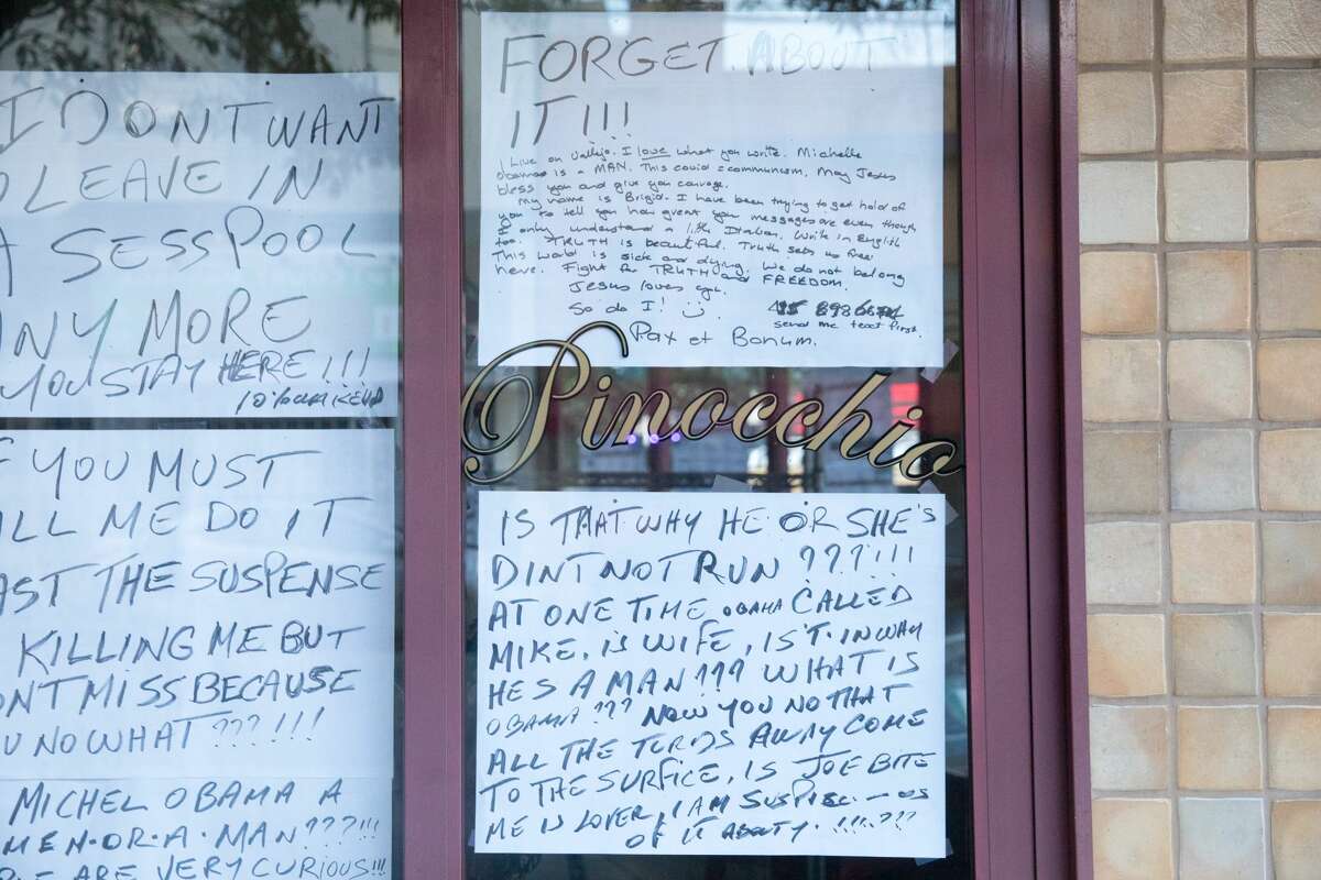 The windows of Trattoria Pinocchio restaurant in the North Beach neighborhood of San Francisco, California on July 30, 2020. They are covered with homemade written signs that are creating a stir.