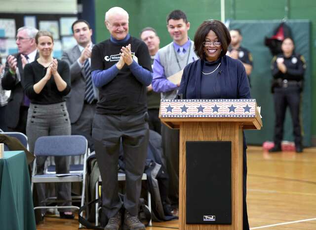 Then-Connecticut State Rep. Elect Patricia Wilson (at podium) of Ashford, Conn., a descendant of enslaved couple in Guilford, Montrose and Phillis, is given a standing ovation after delivering the keynote address at Elisabeth C. Adams Middle School in Guilford during the Witness Stones Installation Ceremony in 2018. The Witness Stone Project remembers and commemorates the enslaved of Guilford by students from Elisabeth C. Adams Middle School.