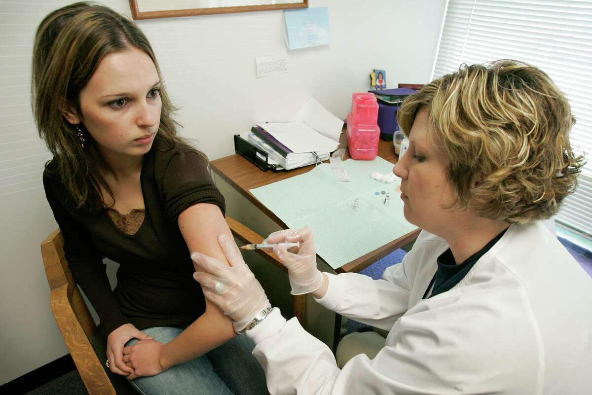 A college student gets a mumps immunization shot in this file photo.