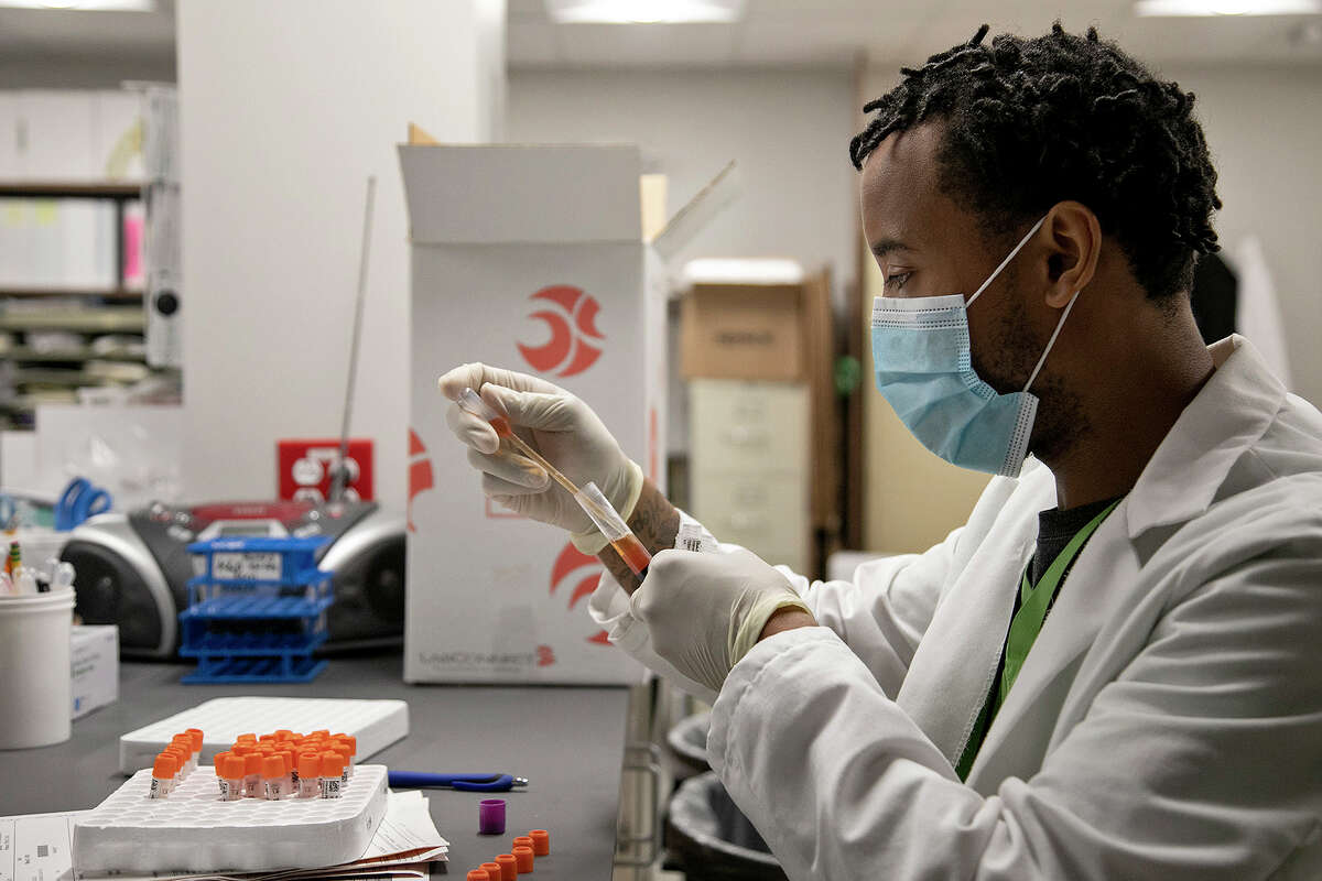 Lab technician D'Andre White works in the laboratory at Clinical Trials of Texas, Inc. in San Antonio on Wednesday, July 29, 2020, the day before clinical trials for a COVID-19 vaccine began there.