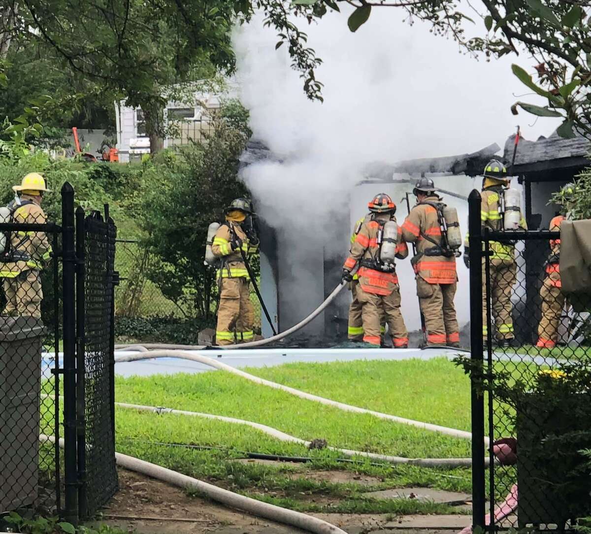 Firefighters at the scene of a pool house fire in Brookfield, Conn., the morning of July 31, 2020.