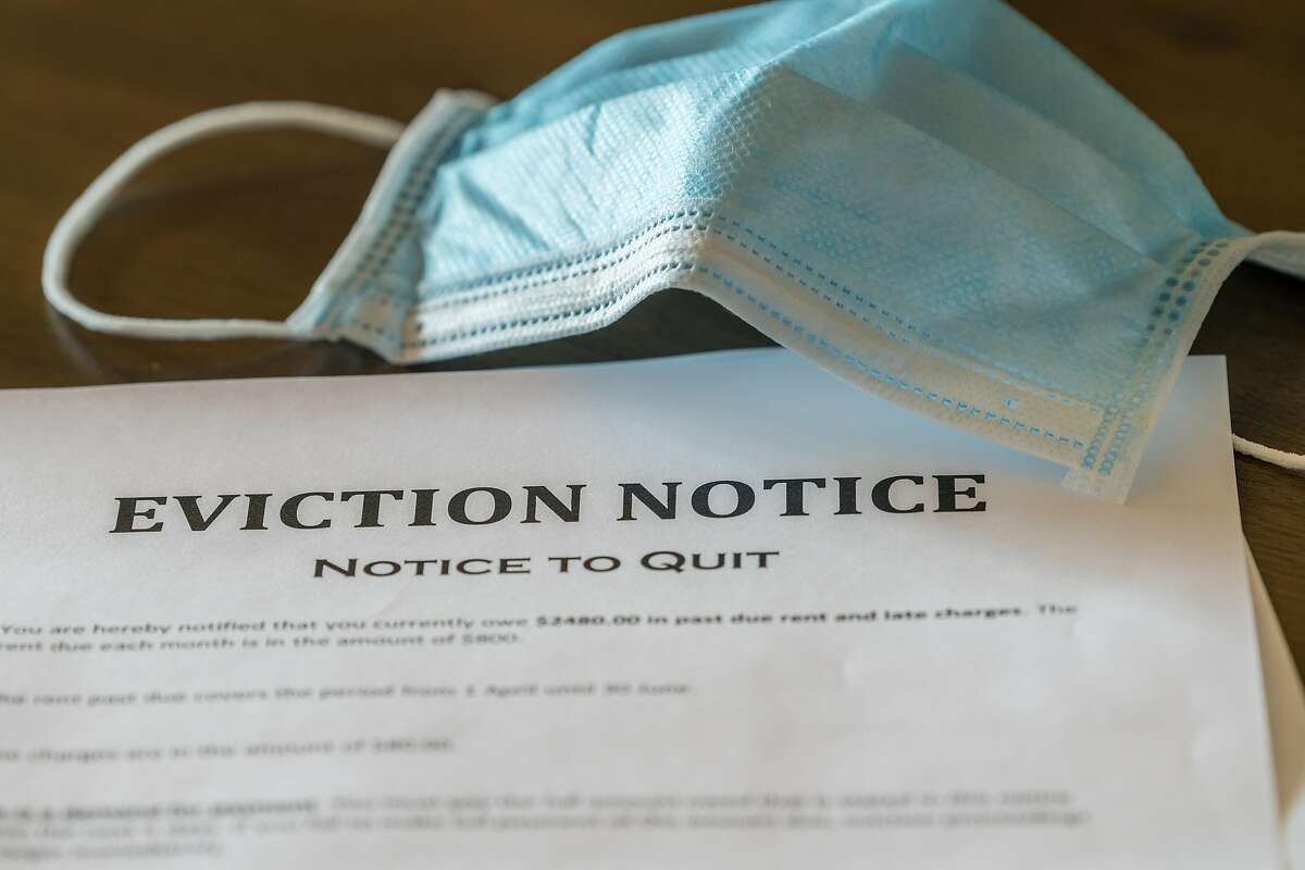 File image of a face mask over an eviction notice document.