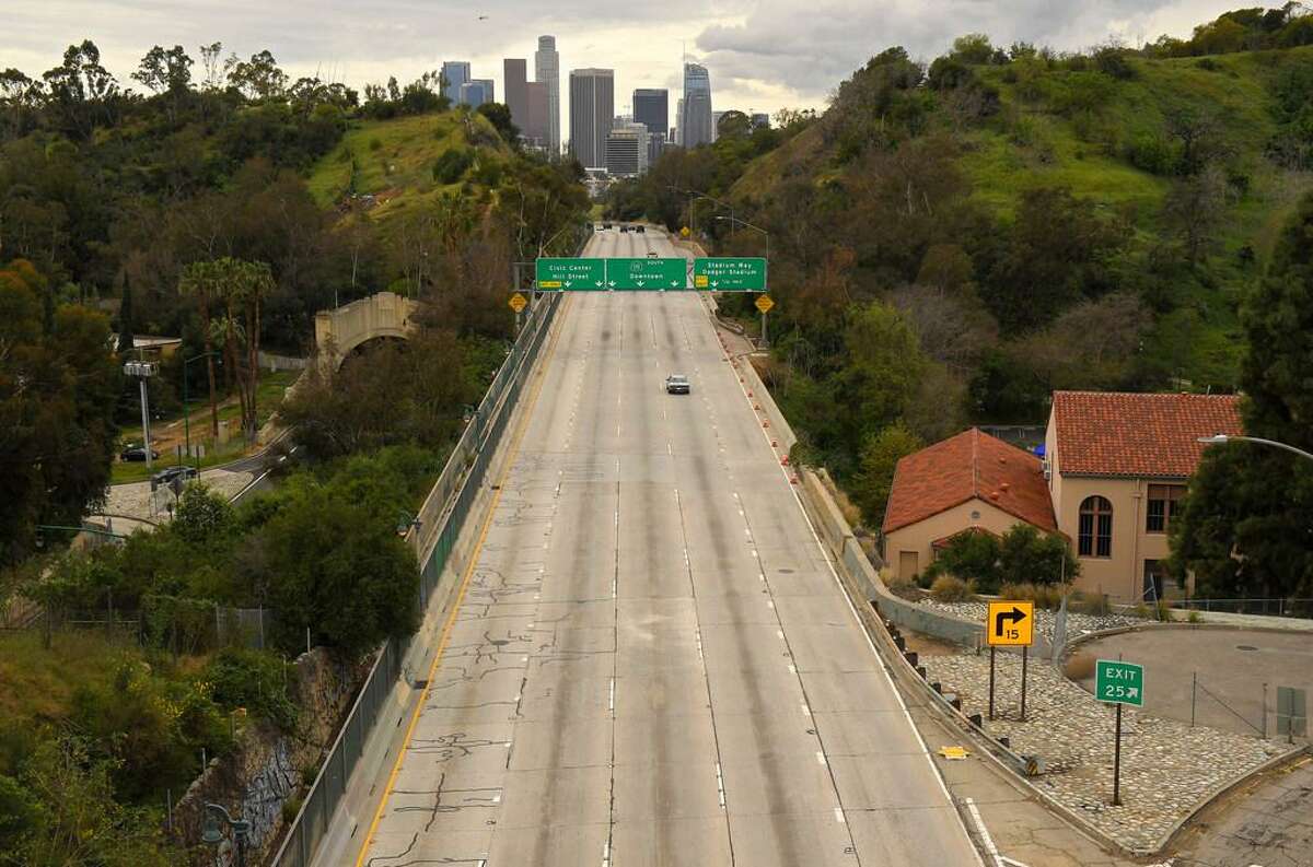 Extremely light traffic moves along the 110 Harbor Freeway toward downtown Los Angeles on a Friday in March. Traffic would normally be bumper to bumper during this time of day, but the shelter-in-place is keeping residents home.