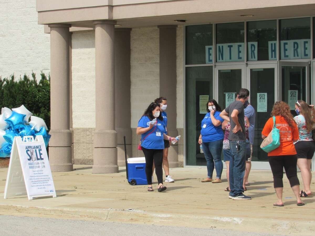 United Way members and volunteers regulate the flow of people into the appliance sale on Saturday. United Way of Midland County and Whirlpool Corporation partnered to provide an appliance sale Aug. 1-2 at the former Younkers store in the Midland Mall.