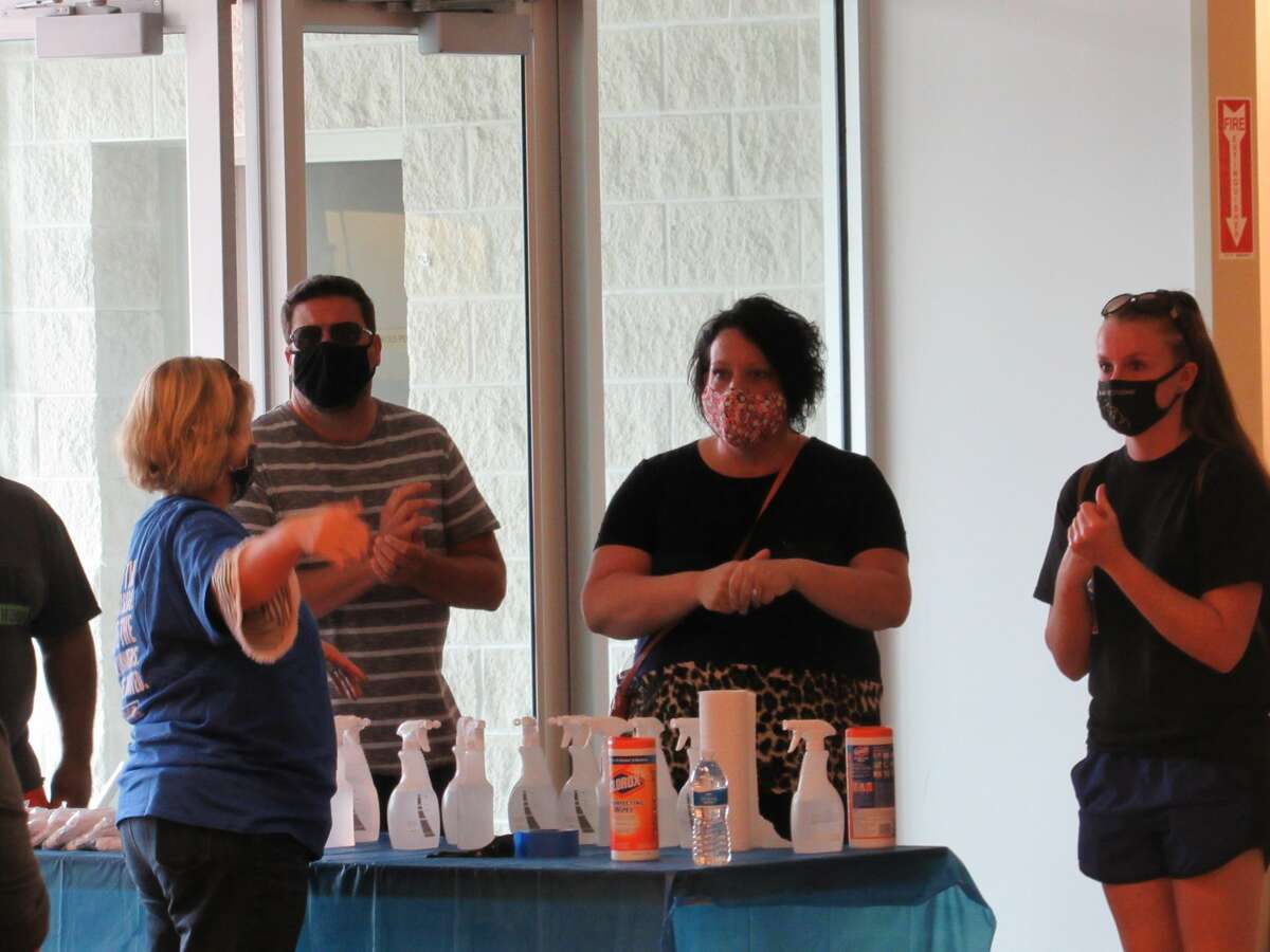 People sanitize their hands as they enter the appliance sale on Saturday. United Way of Midland County and Whirlpool Corporation partnered to provide an appliance sale Aug. 1-2 at the former Younkers store in the Midland Mall.