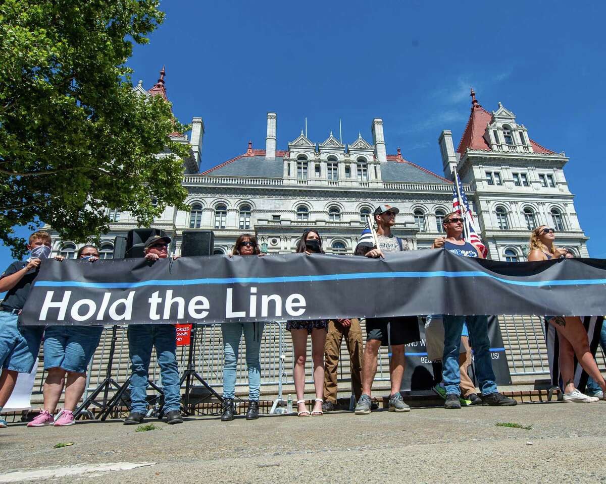 Participants hold a “Hold the Line” banner during a rally in support of police outside the New York State Capitol building in Albany, NY, on Saturday, Aug. 1, 2020 (Jim Franco/Special to the Times Union.)