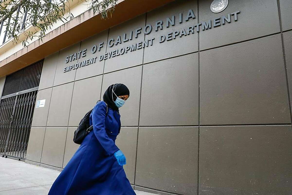 A woman walks by the Employment Development Department office on Monday, June 15, 2020 in San Francisco, California.